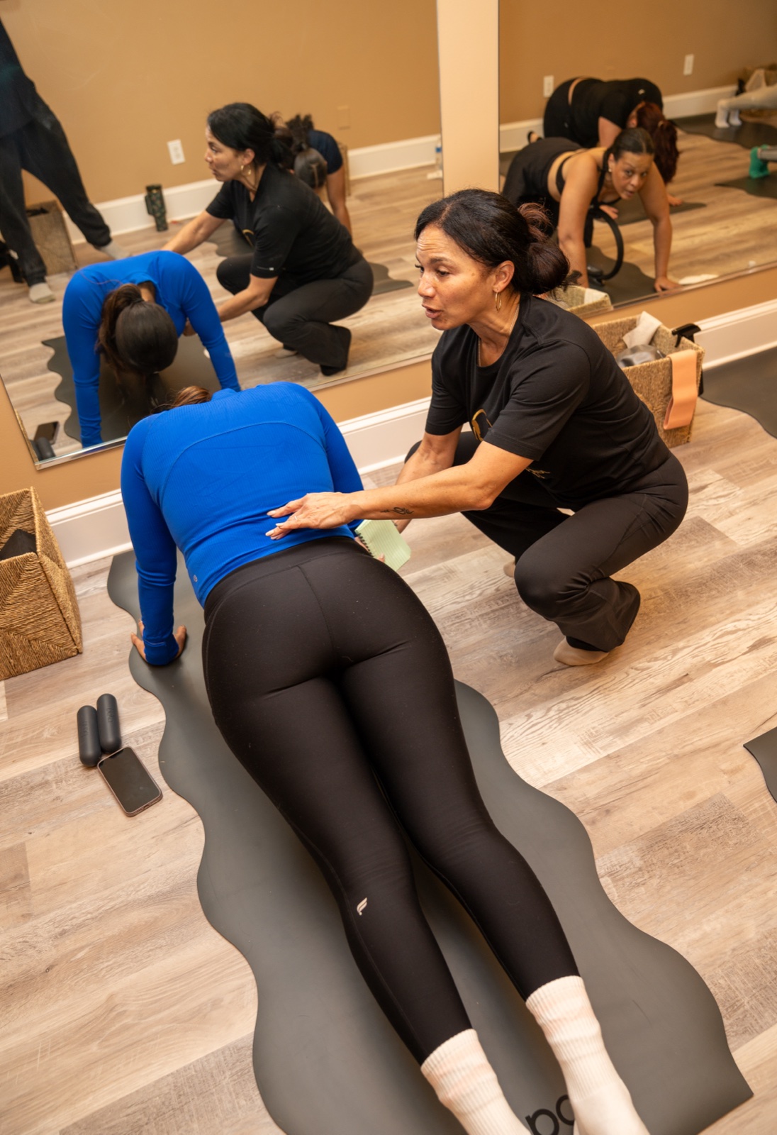 A Pilates instructor coaching a member at Core Control Pilates