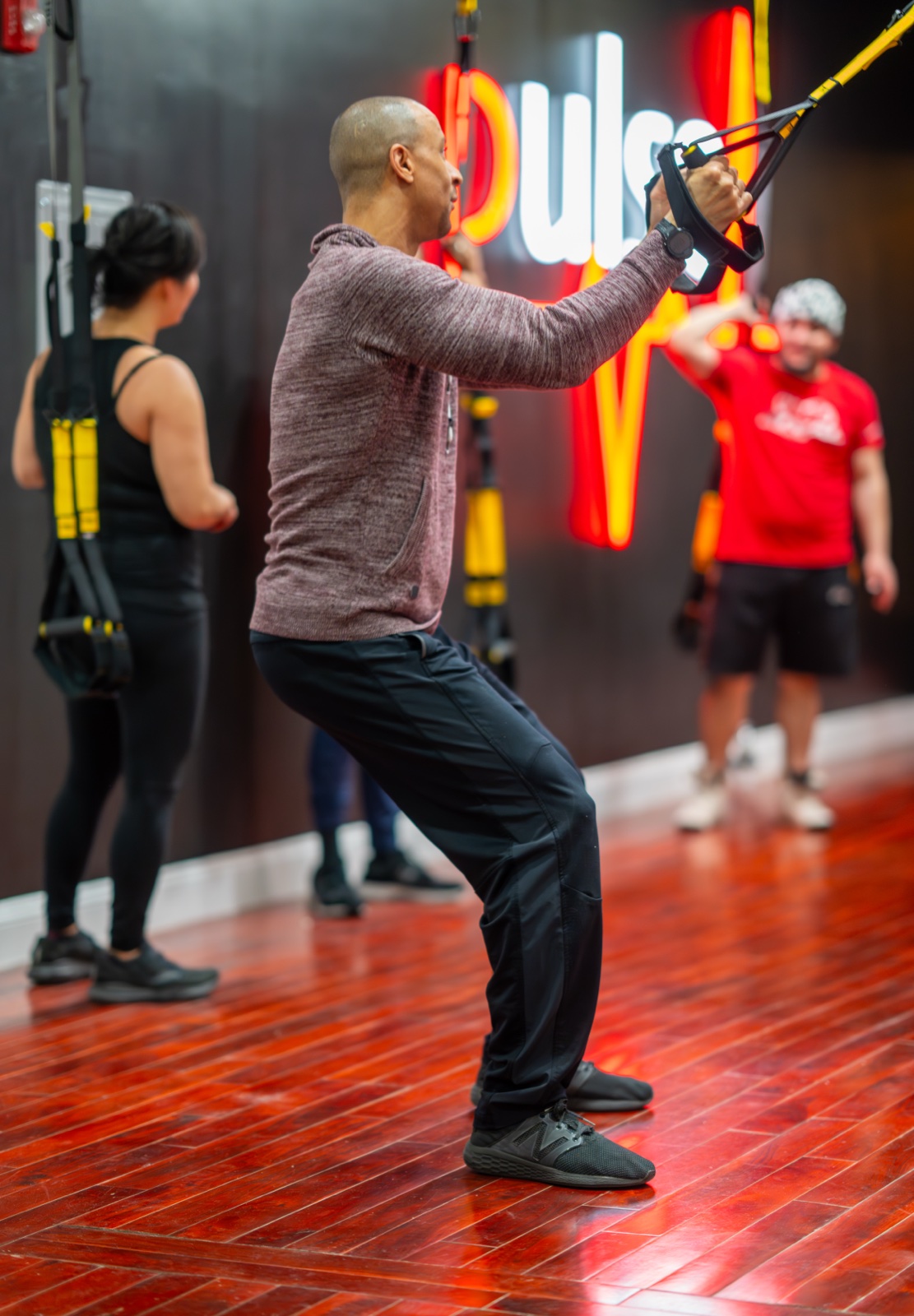 A member training on the TRX straps at the Pulse studio