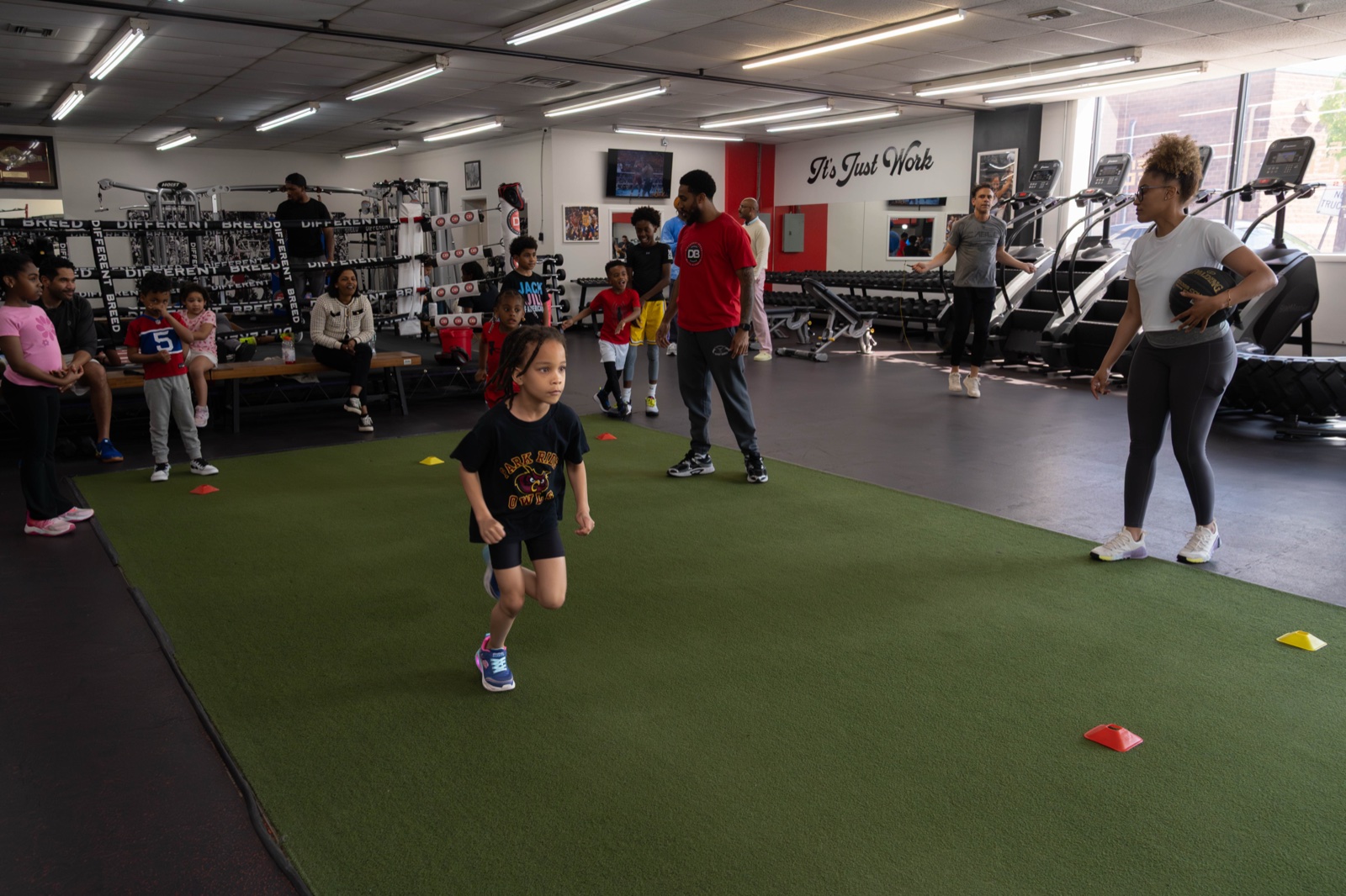 Youth athletes training speed and agility on the turf